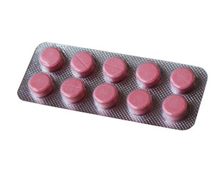Tablets pink in the package isolated on a white background. Drugs, health, treatment.