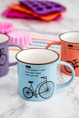 Colorful Modern Ceramic Mugs on  White Wooden Background