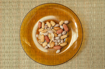 Top view of Peanut in  plate on the bamboo mats background