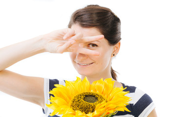 Girl being funny , holding a sunflower
