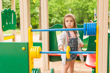 little girl on the summer playground