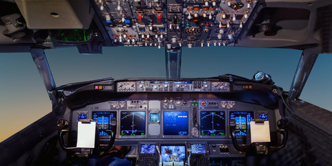 Interior of the cockpit Airplane flying above tropical sunset - obrazy, fototapety, plakaty