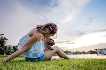 French Bulldog and owner in the Morning sunshine ,lake view Green park