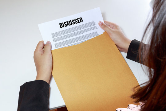 Businesswoman hands holding the dismissed document in envelope