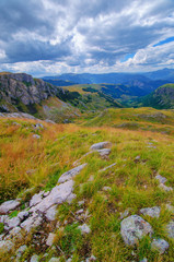 Montenegro, national park Durmitor, mountains and clouds panorama. Sunlight lanscape. Nature travel background