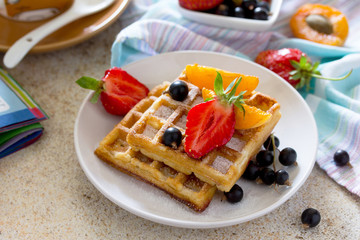 Traditional Belgian waffles with fresh berries on the stone brow