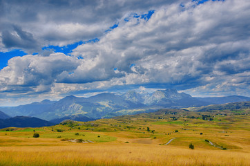 Fototapeta premium Montenegro, national park Durmitor, mountains and clouds panorama. Sunlight lanscape. Nature travel background