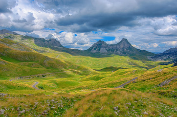Obraz premium Montenegro, national park Durmitor, mountains and clouds panorama. Sunlight lanscape. Nature travel background