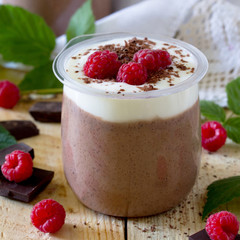 Homemade chocolate mousse with raspberries on a table in a rusti