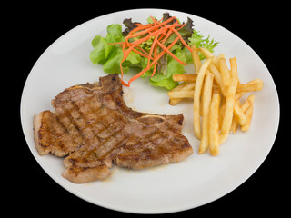 Tender grilled porterhouse or t-bone steak served with golden French fries and fresh green herb...
