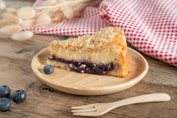 Blueberry cake on wood plate.