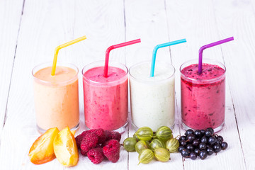 Smoothie in a glass and fresh fruits and berries