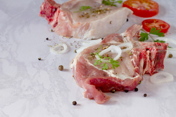 Delicious piece of fresh meat on the bone with aromatic herbs an