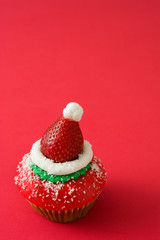 Santa hat cupcake on red background

