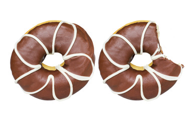 Two delicious dark chocolate donuts glazed with white flower shapes isolated on white background. One sweet donut with icing sugar was bitten.