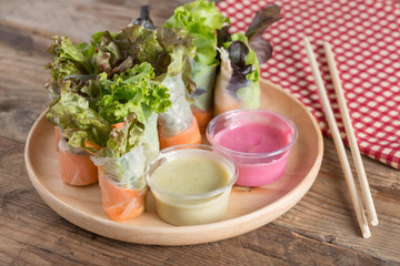 Salad roll vegetables with two salad dressing.
