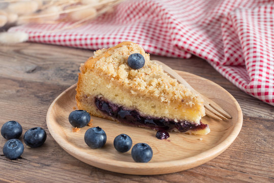 Blueberry cake on wood plate.