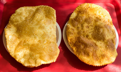 two tchebourek with meat on a table