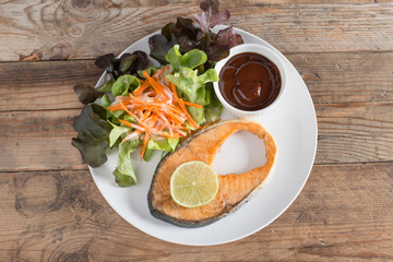 Grilled Salmon with barbeque sauce and fresh salad. Top view.