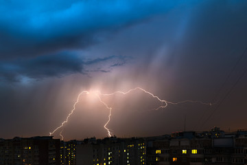 Storm clouds, heavy rain. Thunderstorm and lightning over the city.