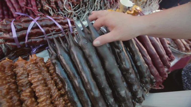 National Georgian sweet dish named churchhela prepared with a hazelnut or walnut and boiled, mixed with flour grape juice.