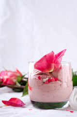 Strawberry dessert in glasses and pink rose, decorated with sugar hearts. Valentines Day background
