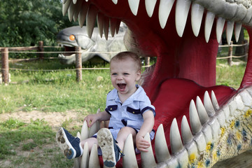 Boy in jaws of dinosaur