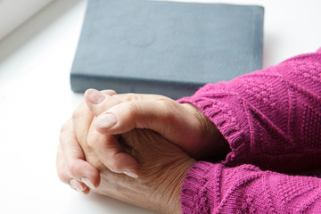 elderly women hands crossed in prayer 