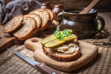 A slice of country bread with homemade lard and cucumber. - obrazy, fototapety, plakaty