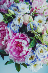 Beauty bunch of pink peonies peony and blue eustoma roses flowers, on white background. Lovely summer bridal bouquet. Wedding concept. Card, text place, copy space. Floral wallpaper