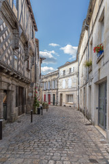 Naklejka na ściany i meble Cognac, France. One of the streets in the medieval quarter