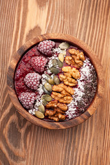 Smoothie with raspberries in a bowl, chia seeds, walnuts and flax seeds. Super Foods
