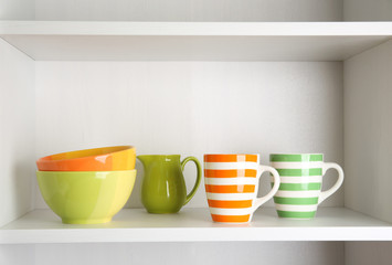 Tableware on shelf in the kitchen cupboard