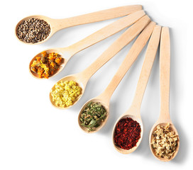 Natural flower and herb selection in wooden spoons isolated on white