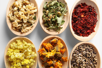 Natural flower and herb selection in wooden spoons, close up