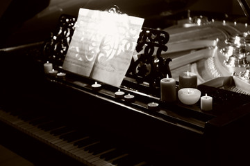 Fototapeta na wymiar Piano with candles and music notes