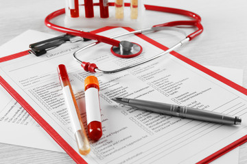 Blood samples and stethoscope on medical report