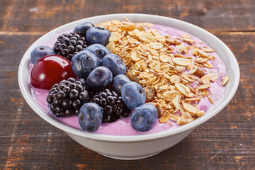 Dish of yogurt smoothie, fresh berries and muesli