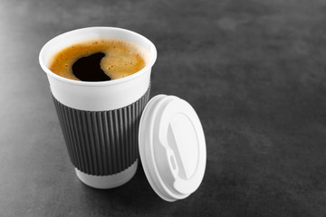 Coffee-to-go. Paper cup of coffee on the table