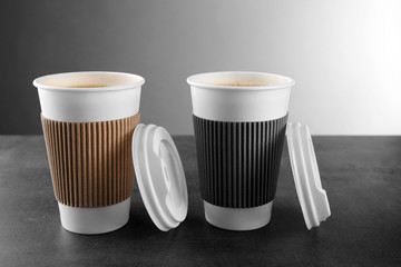 Coffee-to-go. Paper cups of coffee on the table