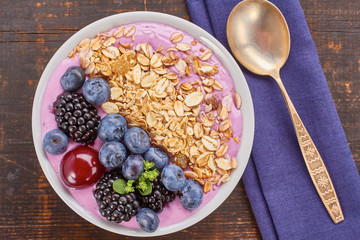 Dish of yogurt smoothie, fresh berries and muesli