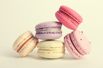 Heap of colorful tasty macaroons on white background