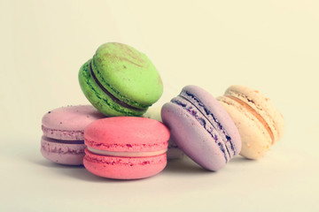 Heap of colorful tasty macaroons on white background