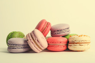 Heap of colorful tasty macaroons on white background