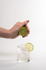 Fototapeta premium Female hand squeezing lime