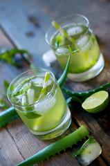 Aloe vera and lime cocktail with mint and ice cubes