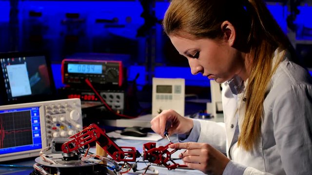 cientist adjusts the robot arm