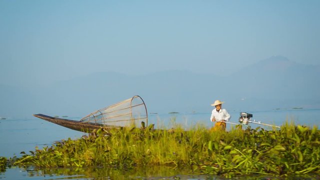 Video 1080p - local fisherman is moving quickly on the boat with a modern engine. Inle Lake, Myanmar