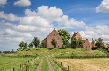 Fototapeta na wymiar Medieval church on a mound in Groningen village Ezinge