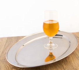 Glass of beer on the silver tray